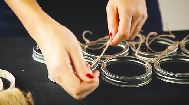 Attach the Mason jar lids together with jute rope.