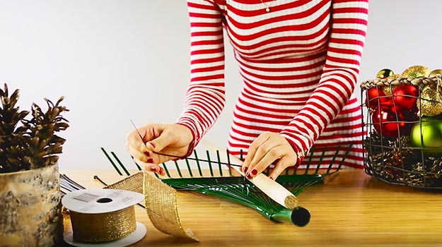 Attach the handle to the rake with plastic tie wraps.