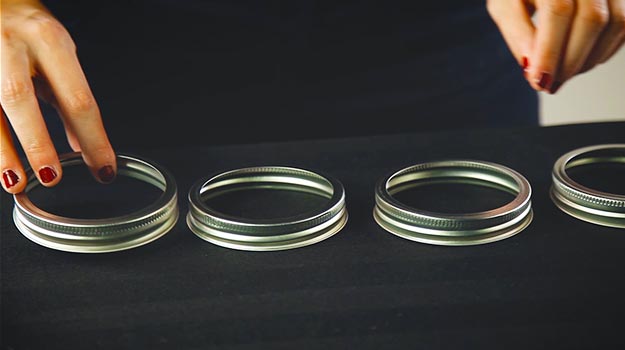 Form a triangle with 10 Mason jar lids on a flat surface.