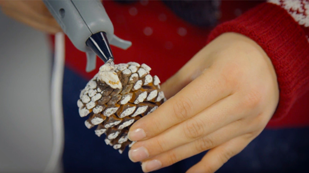 Glue the pine cones on the fir branches